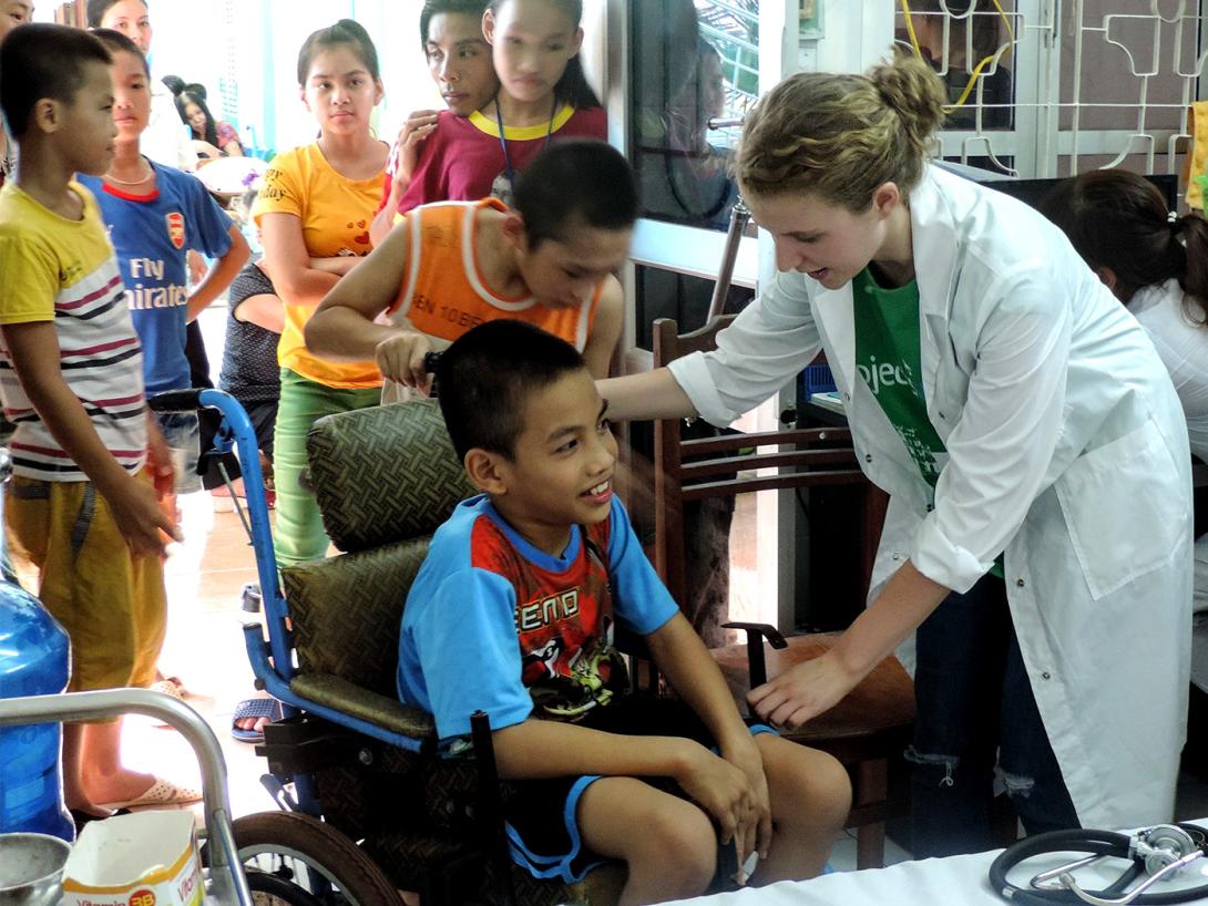 A Vietnamese child is examined by a medical volunteer for a basic health check A medical volunteer in Vietnam participates in a community healthcare outreach
